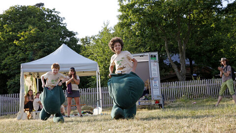 Kinder spielen in Kostümen auf einer Wiese