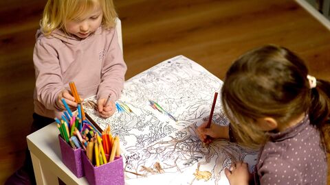 Kinder malen Ausmalbilder mit Buntstiften aus